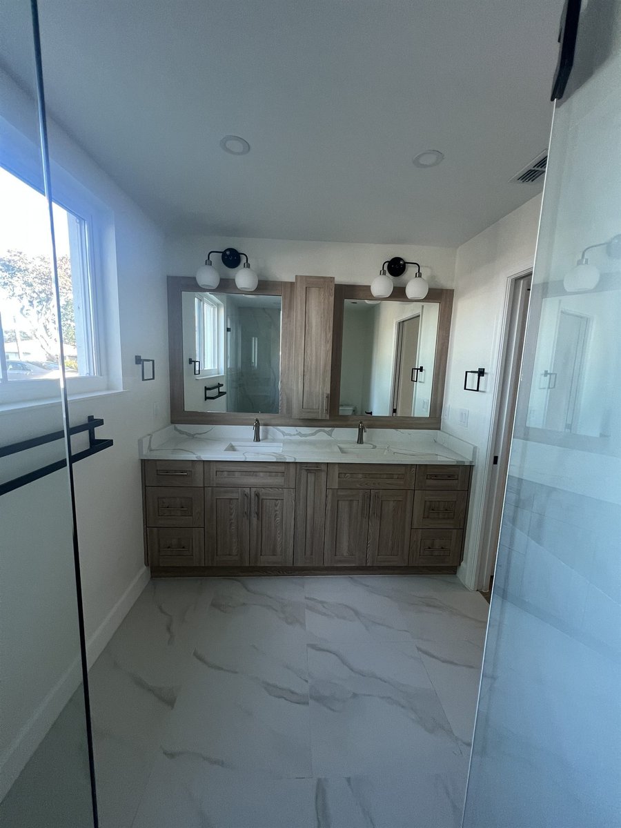 wood vanity double mirror marble accent wall bathroom remodel - optimized
