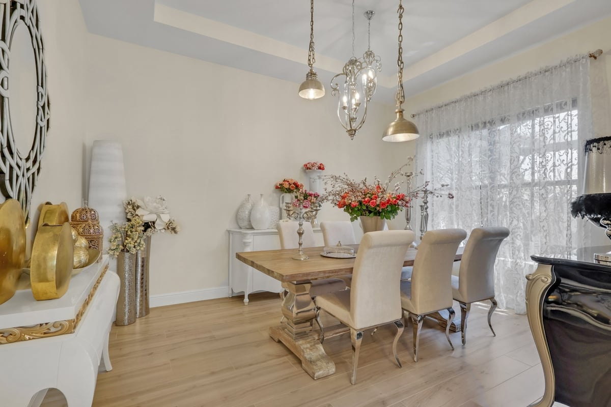 bright dining room with tray ceiling and decorative pendant lights in naples fl full home remodel