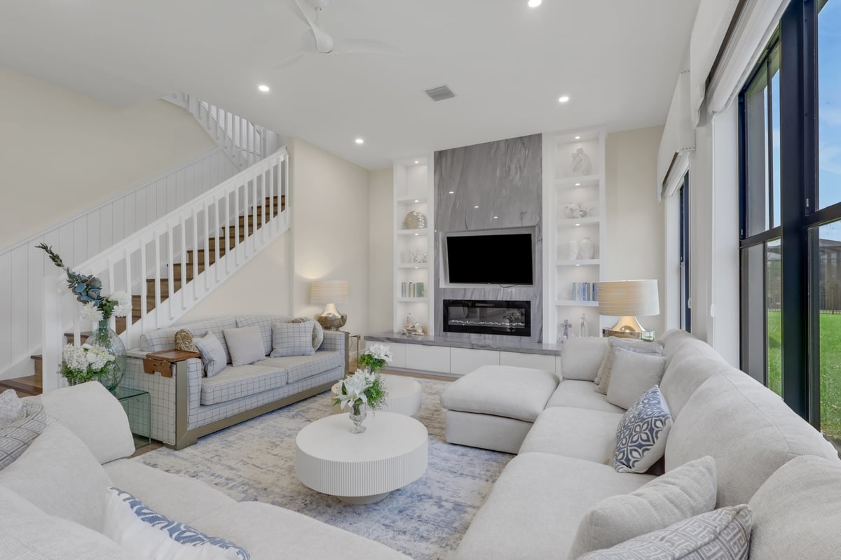 bright living room with marble fireplace built ins and large windows in naples fl full home remodel