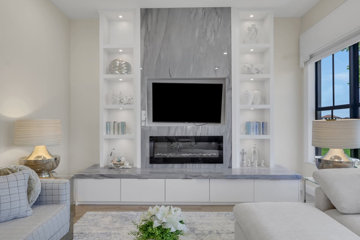 custom marble fireplace wall with illuminated built in shelves in naples fl full home remodel
