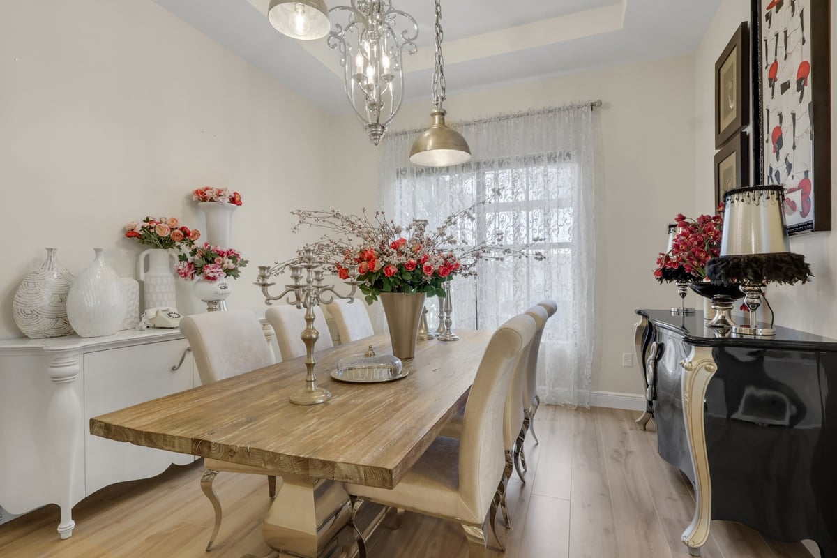 formal dining room with wood table white chairs and floral decor in naples fl full home remodel