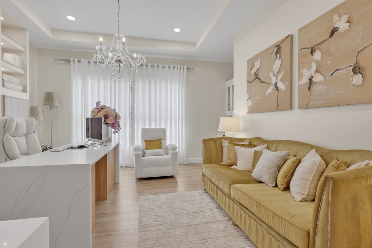 full home remodel home office with mustard sofa floral artwork and chandelier in naples fl