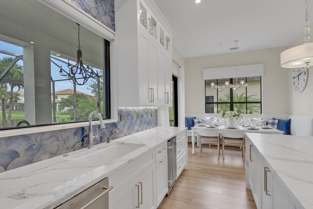 full home remodel kitchen sink wall with blue backsplash and dining nook in naples fl