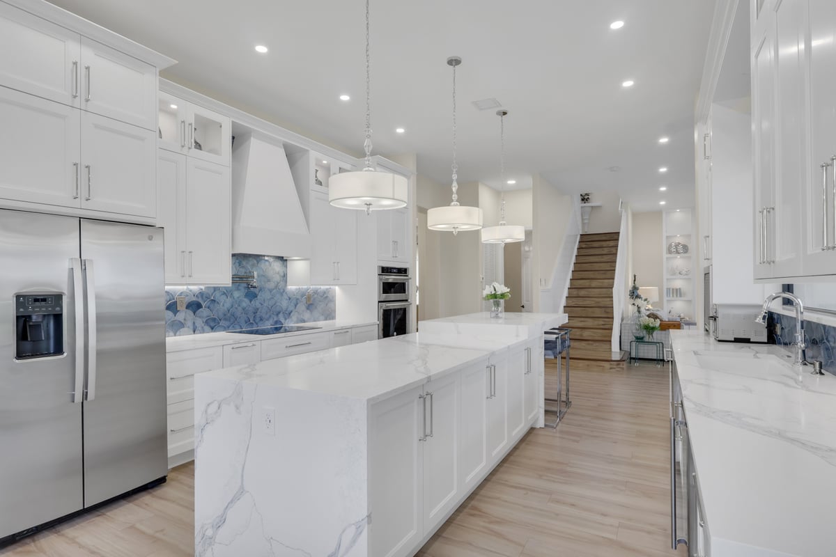 full home remodel kitchen with double island stainless appliances and staircase in naples fl