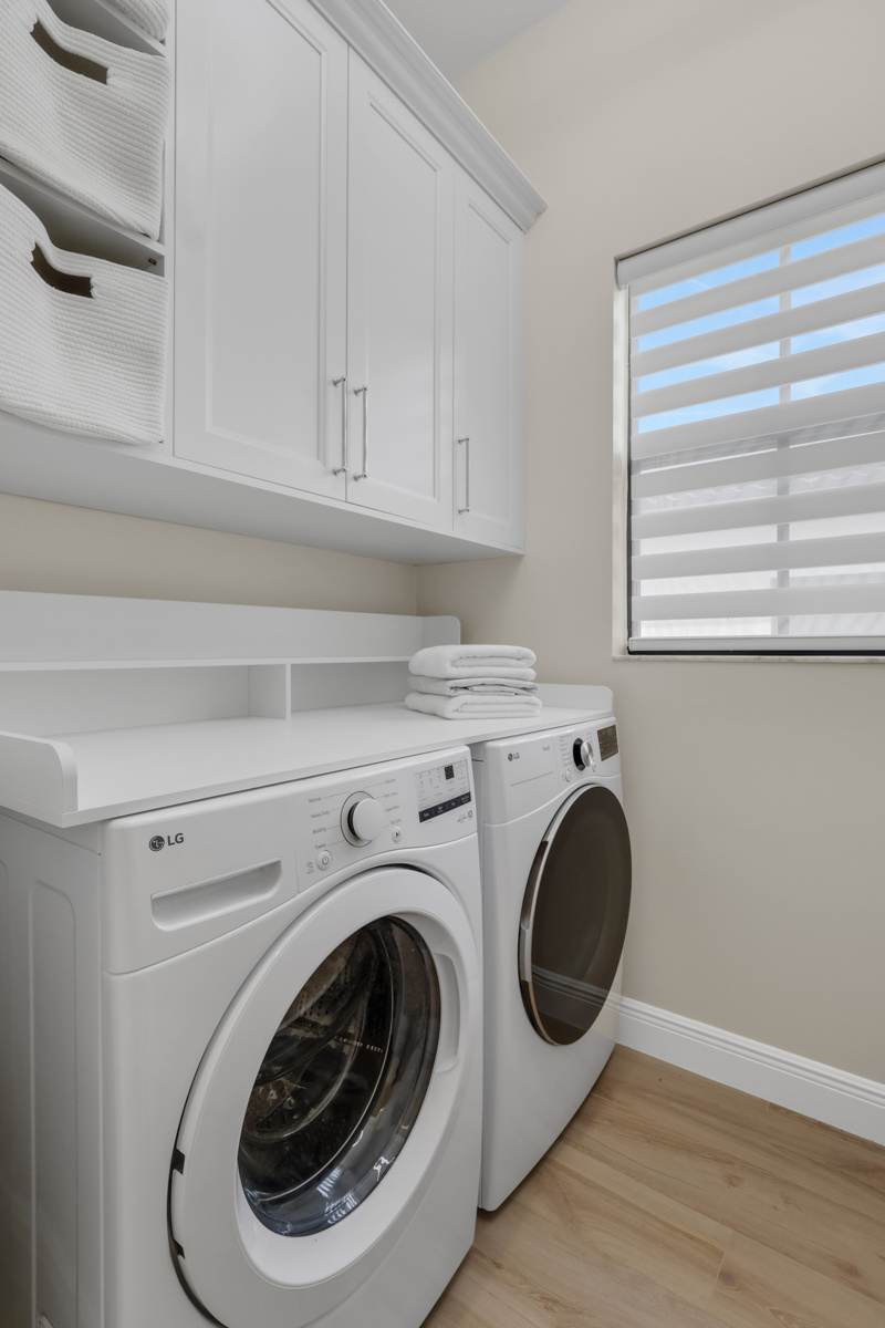 full home remodel laundry room with built in storage and front load appliances in naples fl