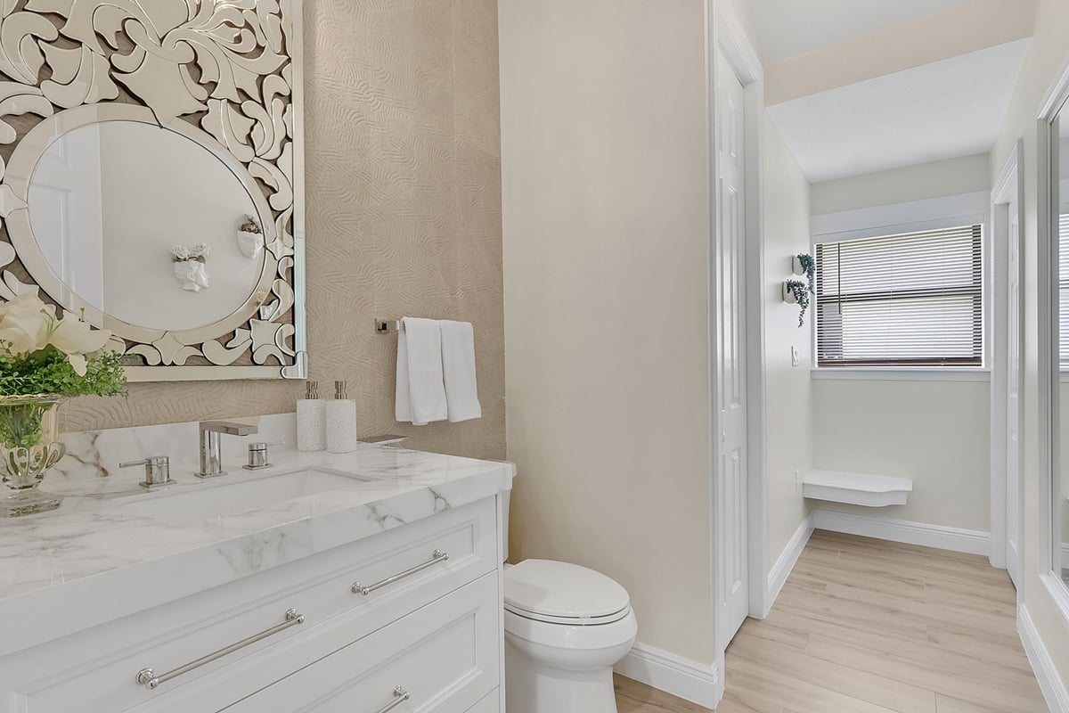 full home remodel powder bathroom with white vanity and hallway in naples fl