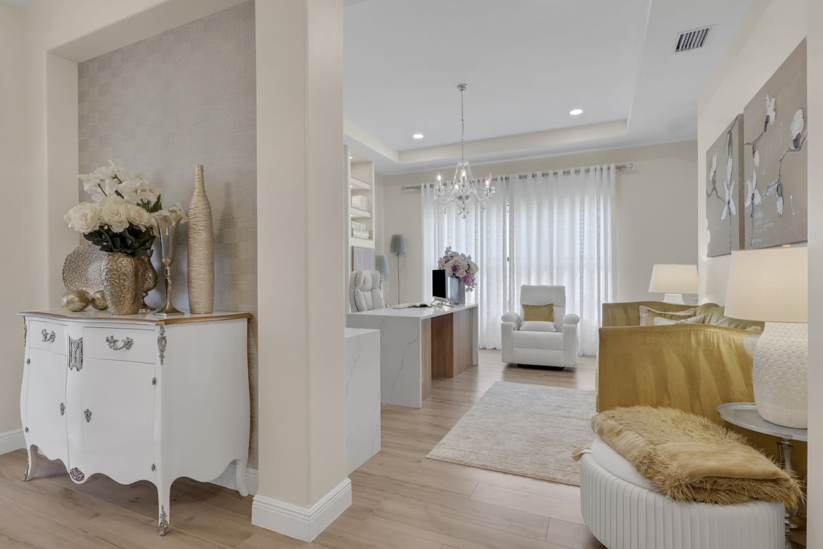 open living area with gold sofa home office and chandelier in naples fl full home remodel