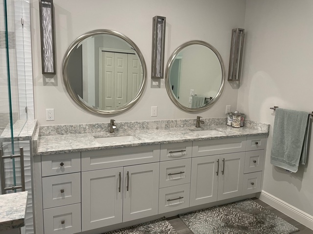 kitchen and bathroom remodel double vanity with stone counter and round mirrors in naples fl