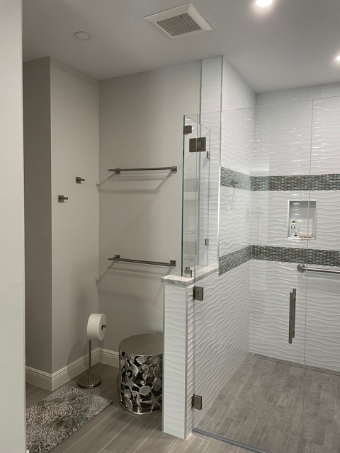 kitchen and bathroom remodel glass shower with white wave tile and gray floor in naples fl
