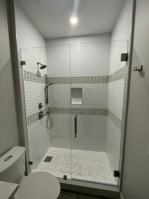 kitchen and bathroom remodel glass shower with white wave tile and mosaic accents in naples fl