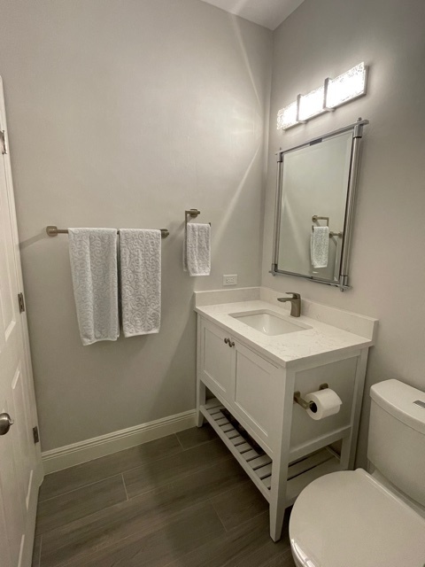 kitchen and bathroom remodel powder room with white vanity and framed mirror in naples fl