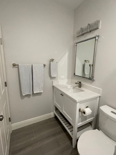 kitchen and bathroom remodel powder room with white vanity gray tile floor and mirror in naples fl