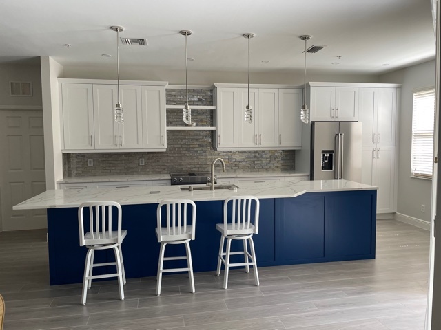 kitchen and bathroom remodel with blue island seating and white cabinetry in naples fl