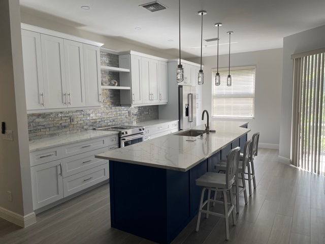 kitchen and bathroom remodel with blue island white cabinets and pendant lights in naples fl