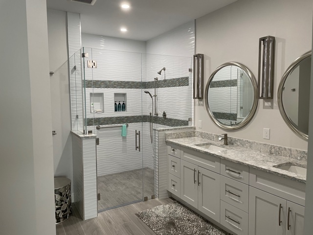 kitchen and bathroom remodel with glass shower double vanity and round mirrors in naples fl