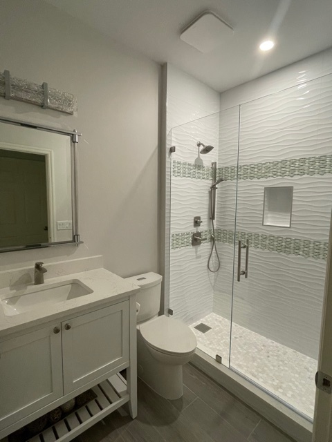 kitchen and bathroom remodel with glass shower white wave tile and vanity in naples fl