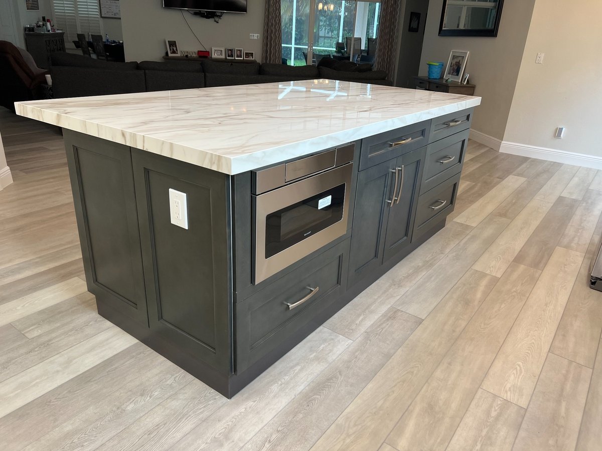 naples fl kitchen remodel dark island with built in microwave drawers and stone countertop