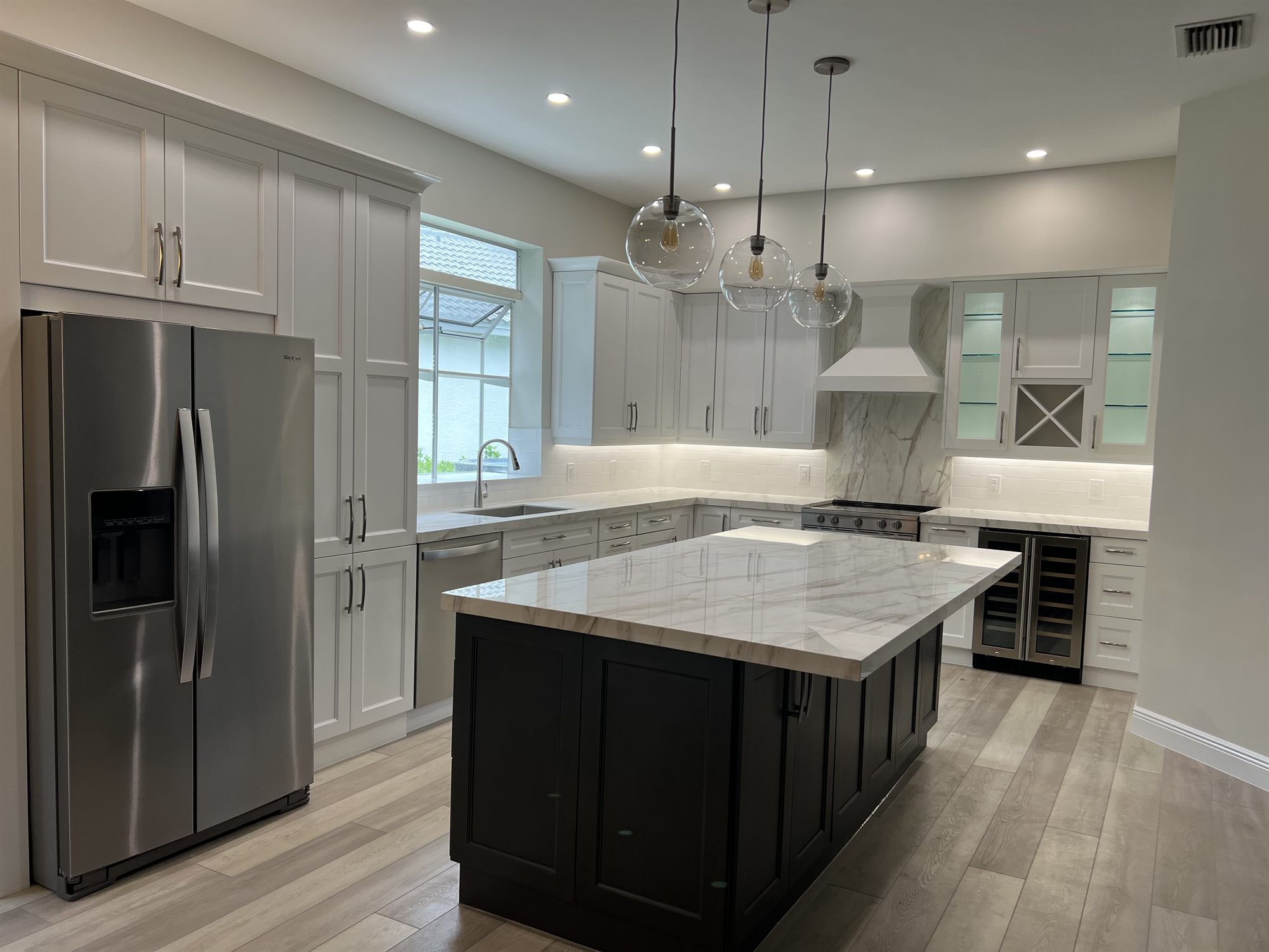 stainless french door fridge white cabinets dark island marble countertop kitchen remodel - optimized