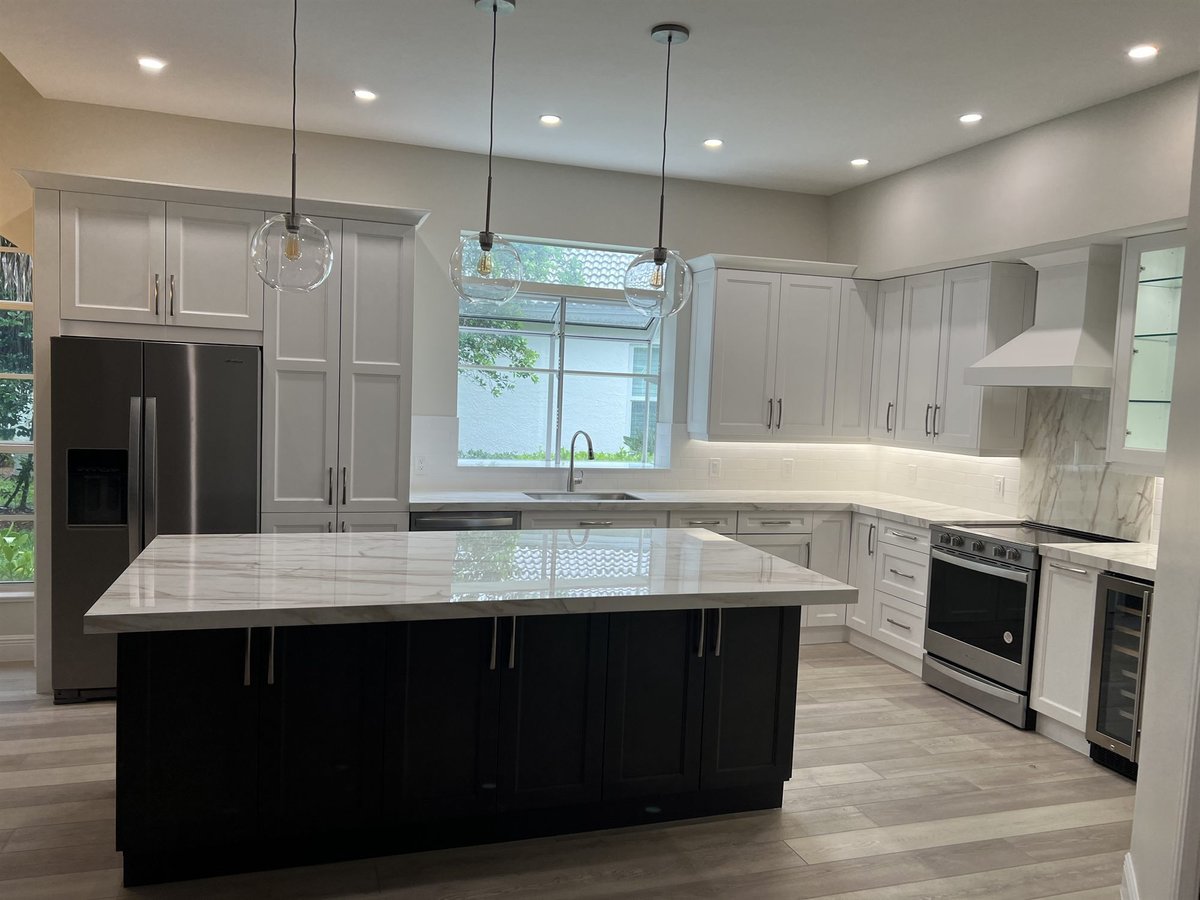 white cabinets dark island marble waterfall countertop stainless range kitchen remodel - optimized
