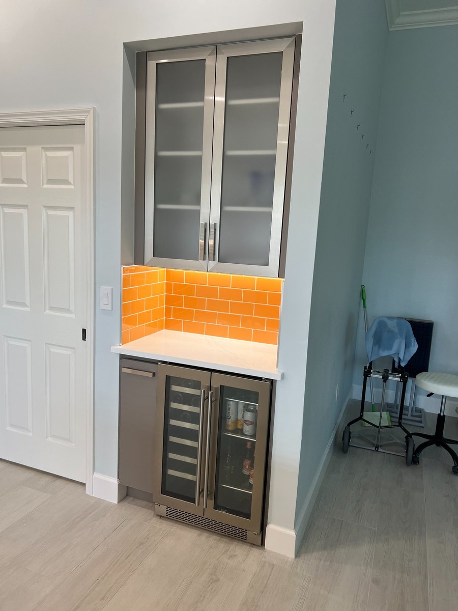 naples fl full home remodel beverage station with frosted glass cabinets orange tile backsplash and wine cooler