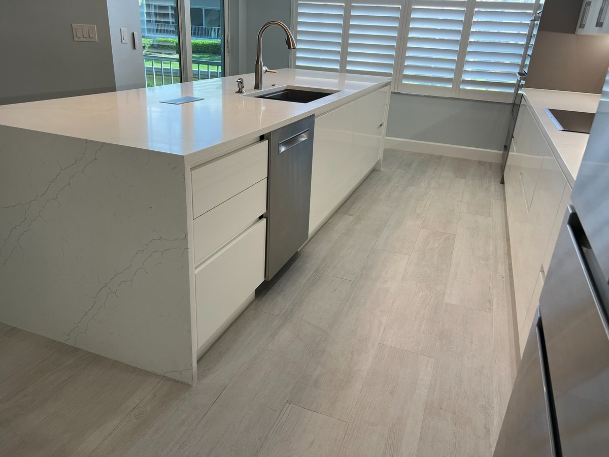 naples fl full home remodel kitchen island with waterfall quartz countertop sink and stainless dishwasher