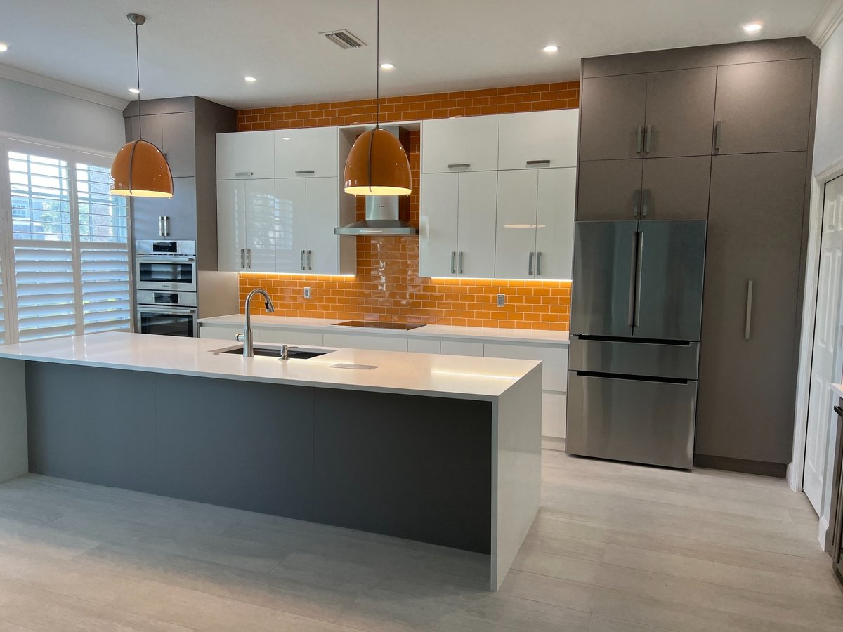 naples fl full home remodel modern kitchen with gray and white cabinets orange backsplash and large island