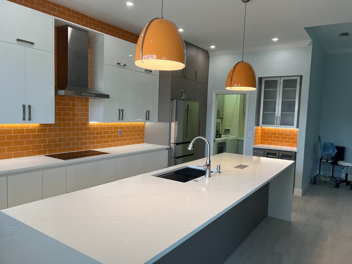 naples fl full home remodel modern kitchen with white quartz island orange backsplash and pendant lights