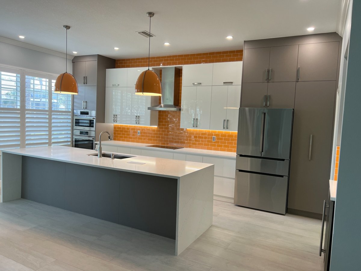 naples fl full home remodel wide kitchen view with quartz island orange backsplash and stainless appliances
