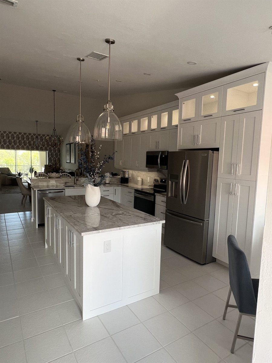 bright white kitchen with center island and stainless refrigerator kitchen remodel - optimized