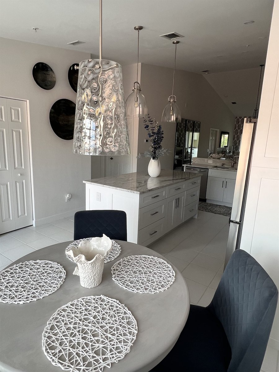 kitchen island and dining space with glass pendant lights kitchen remodel - optimized
