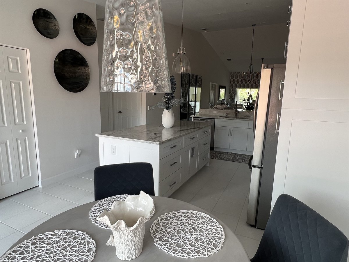 open concept kitchen with decorative range hood and dining area kitchen remodel - optimized