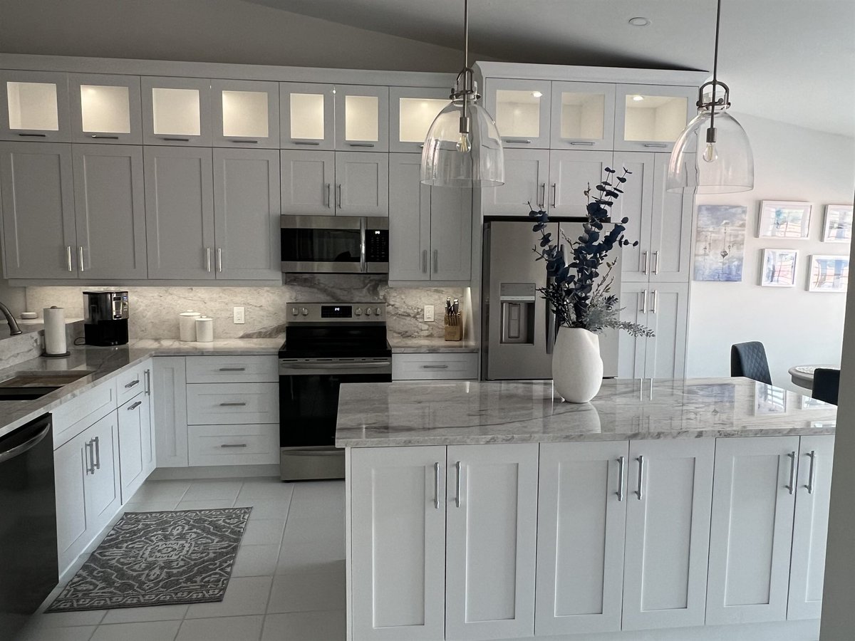white shaker kitchen with marble counters and glass front upper cabinets kitchen remodel - optimized