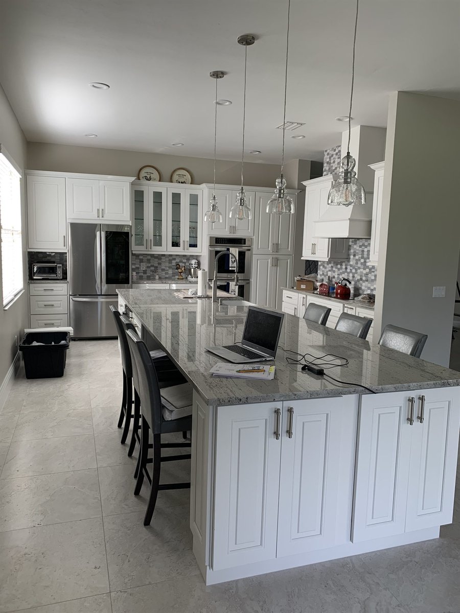 white cabinets with marble island and stainless refrigerator kitchen remodel - optimized