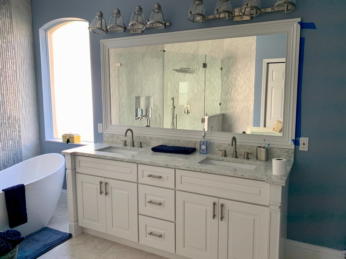 white double vanity and large mirror in naples fl bathroom and kitchen remodel