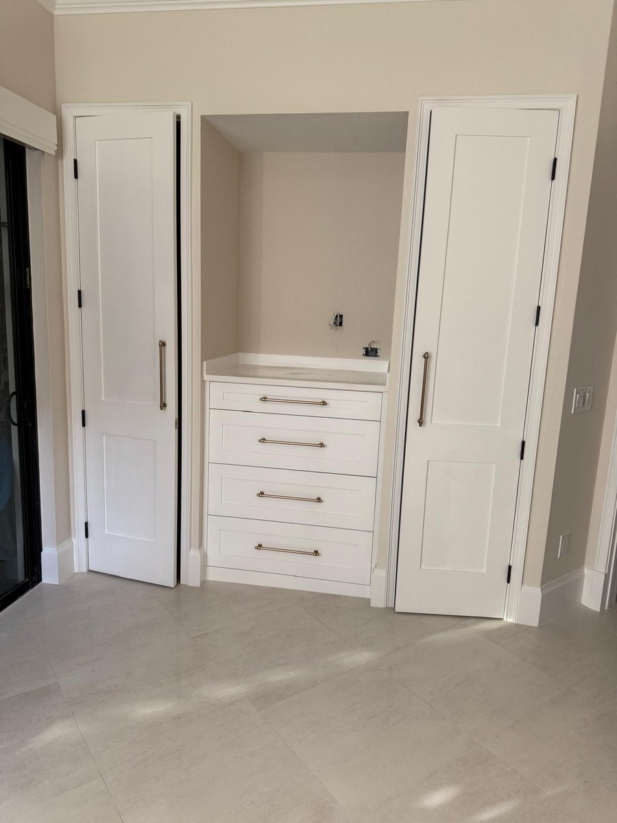full home remodel custom white storage cabinetry with countertop and brass hardware in naples fl