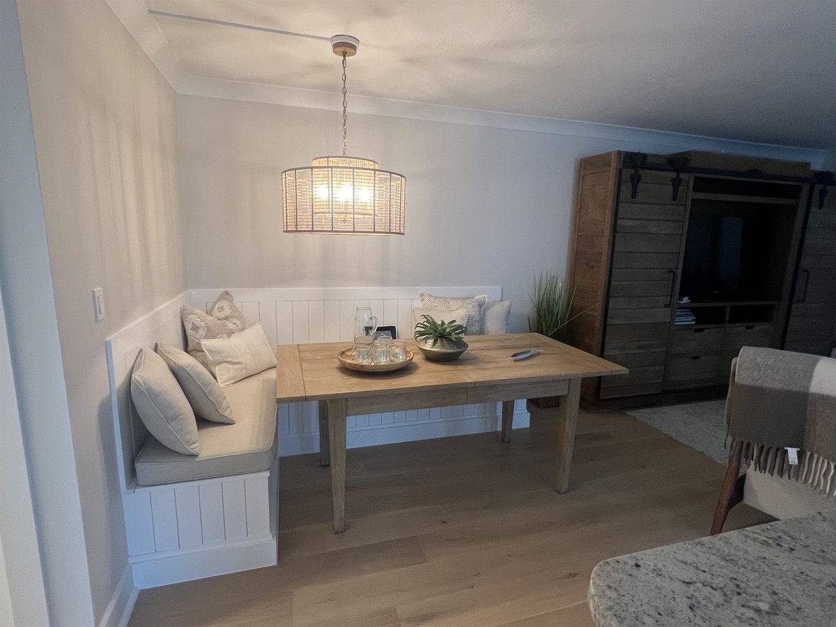 built-in banquette breakfast nook with wood table dining room renovation