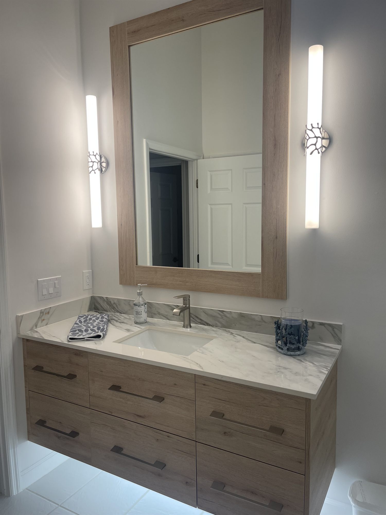 wood framed mirror vanity with dual sconces bathroom remodel - optimized